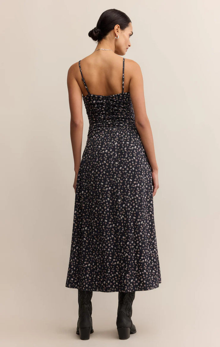  A maxi dress featuring a feminine ditsy floral print, with a  fitted silhouette, a sweetheart neckline, adjustable spaghetti straps, and smocking for a perfectly contoured fit