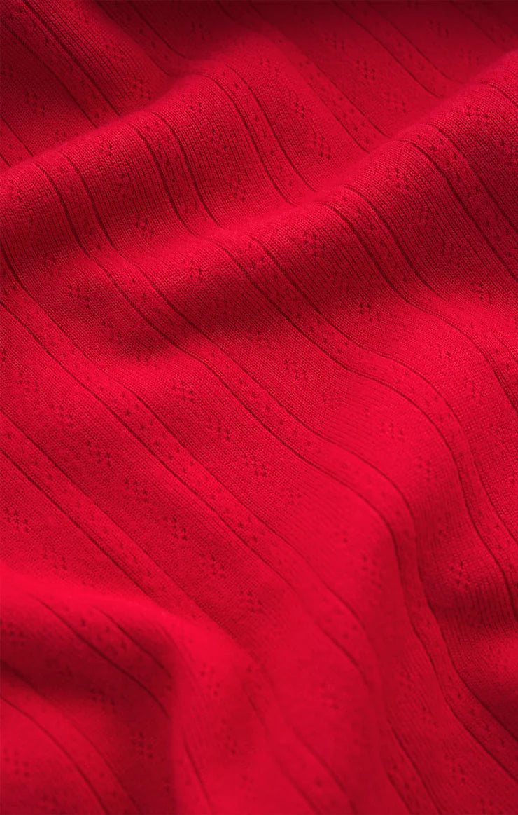 Close-up of red fabric with a textured pattern Z Supply
