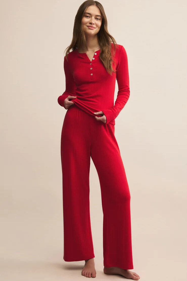 Woman wearing a Z Supply half buttoned red long sleeve pajama top 