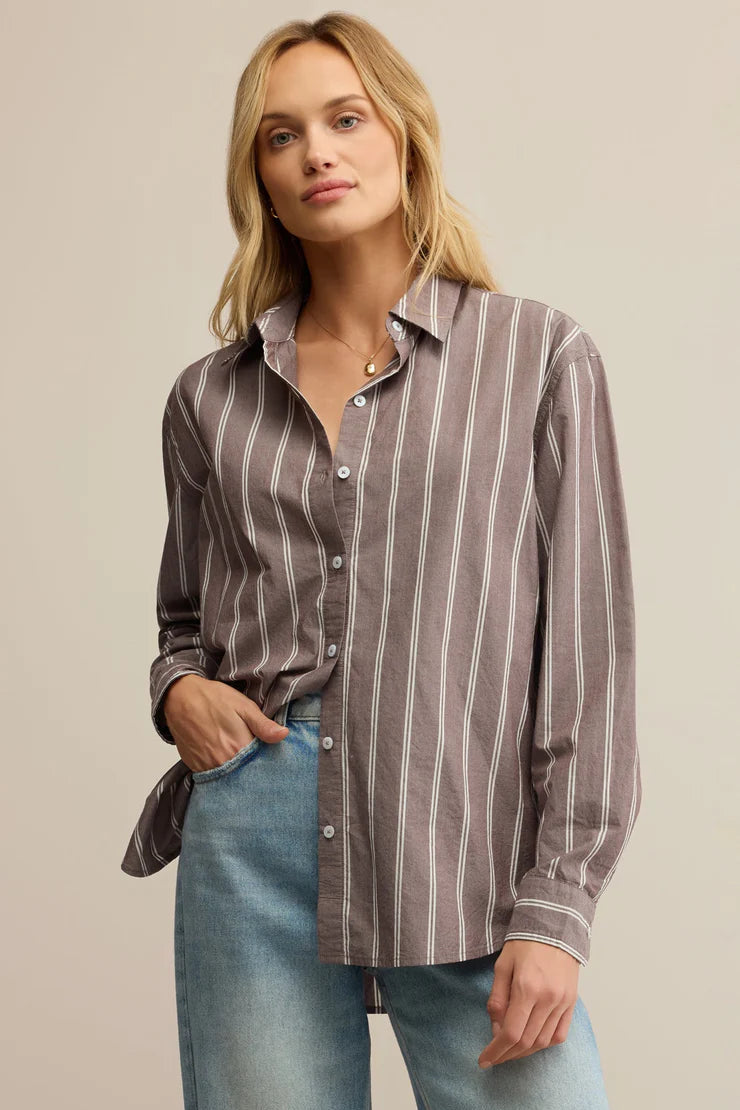 Woman wearing a striped collared button down shirt 