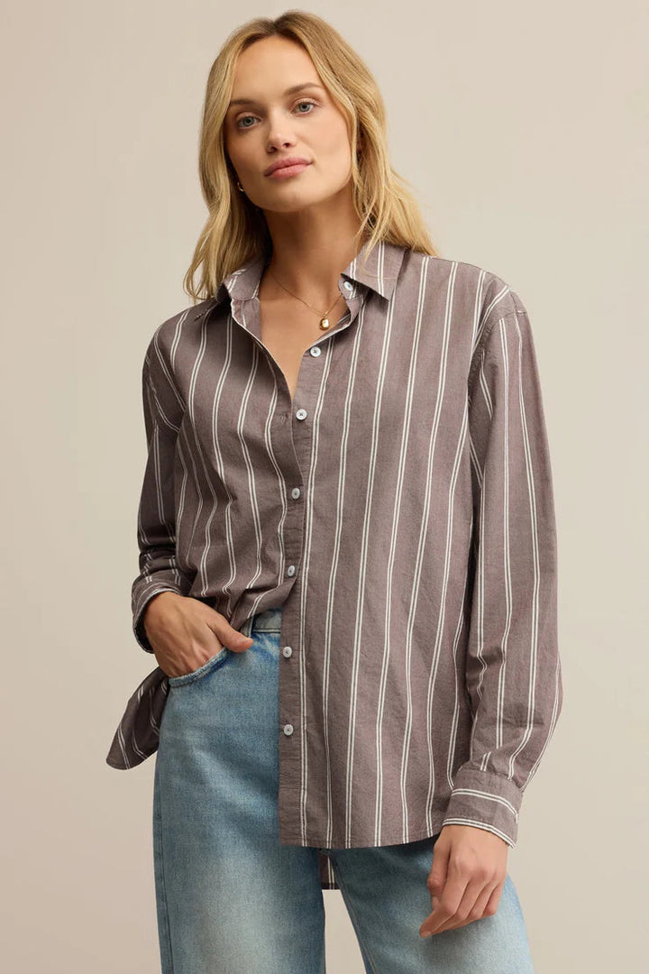 Woman wearing a striped collared button down shirt 