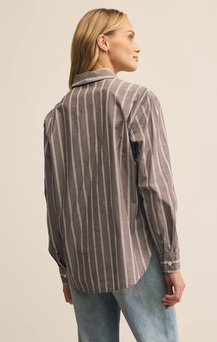 Woman wearing a striped collared button up shirt 