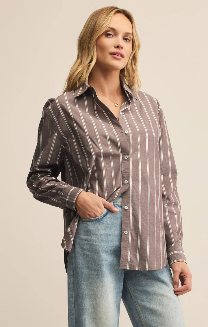 Woman wearing a striped collared button up shirt 