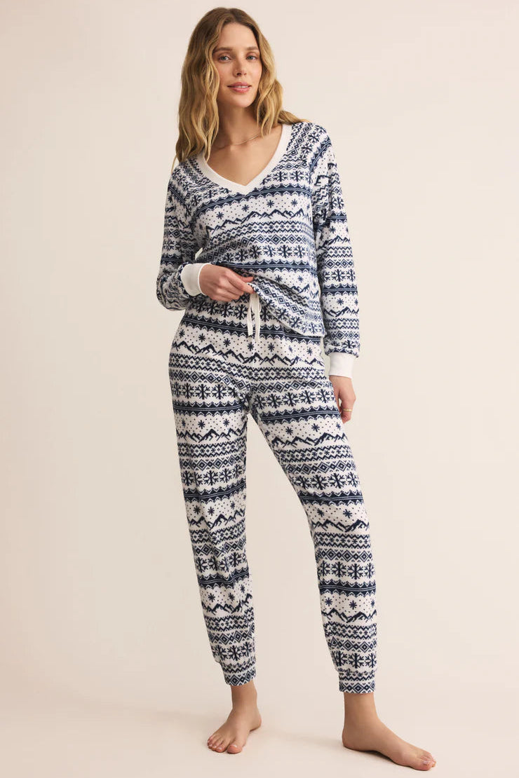 Woman wearing a Z Supply v-neck waffled blue and white winter patterned pajama shirt 