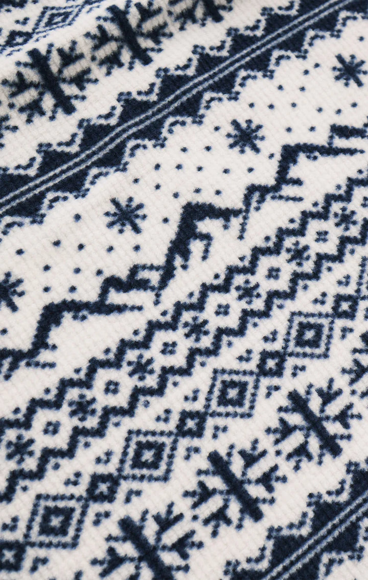 Close-up of a blue and white geometric patterned fabric, mountains and snowflakes Z Supply