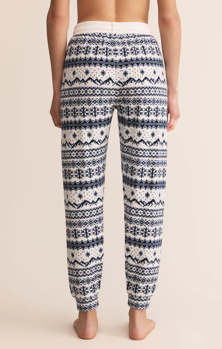 Patterned white and blue winter Z Supply pajama pants worn by a person