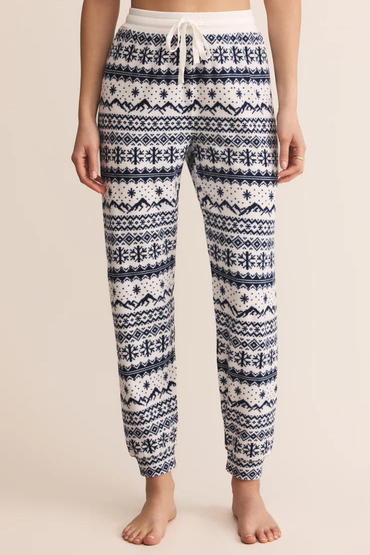 Patterned white and blue winter Z Supply pajama pants worn by a person tie waist