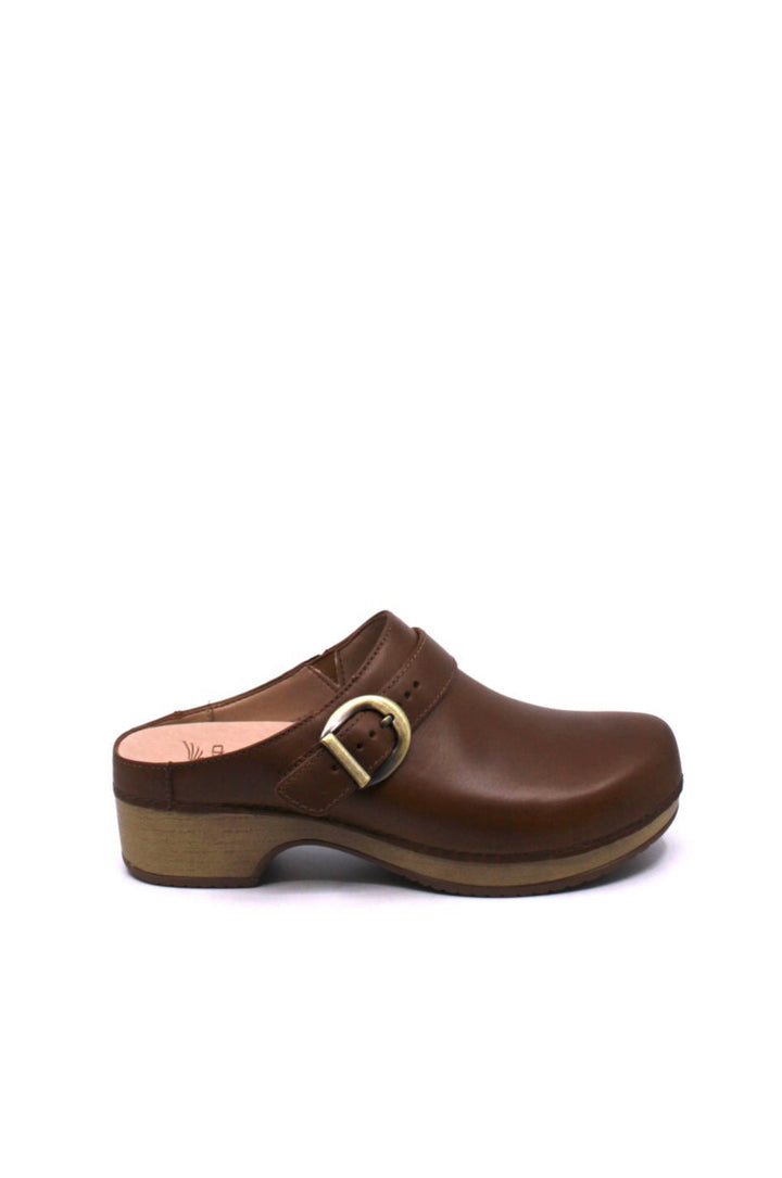 backless clog features a bold buckle and beautiful black leather from dansko