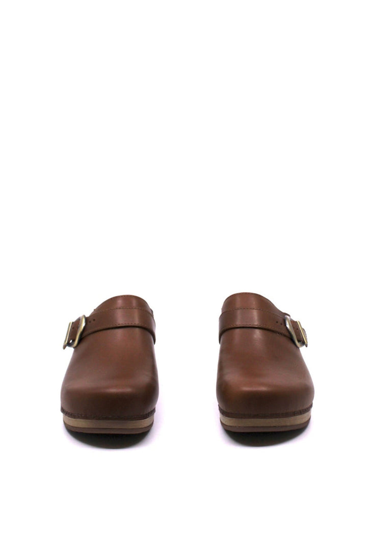 backless clog features a bold buckle and beautiful black leather from dansko