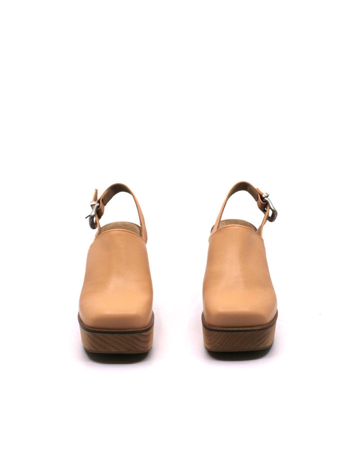 Free People Mallory Clog Natural front view- Dear Lucy
Platform heeled mule clog with a back strap, silver buckle, leather upper, and wooden base in natural.