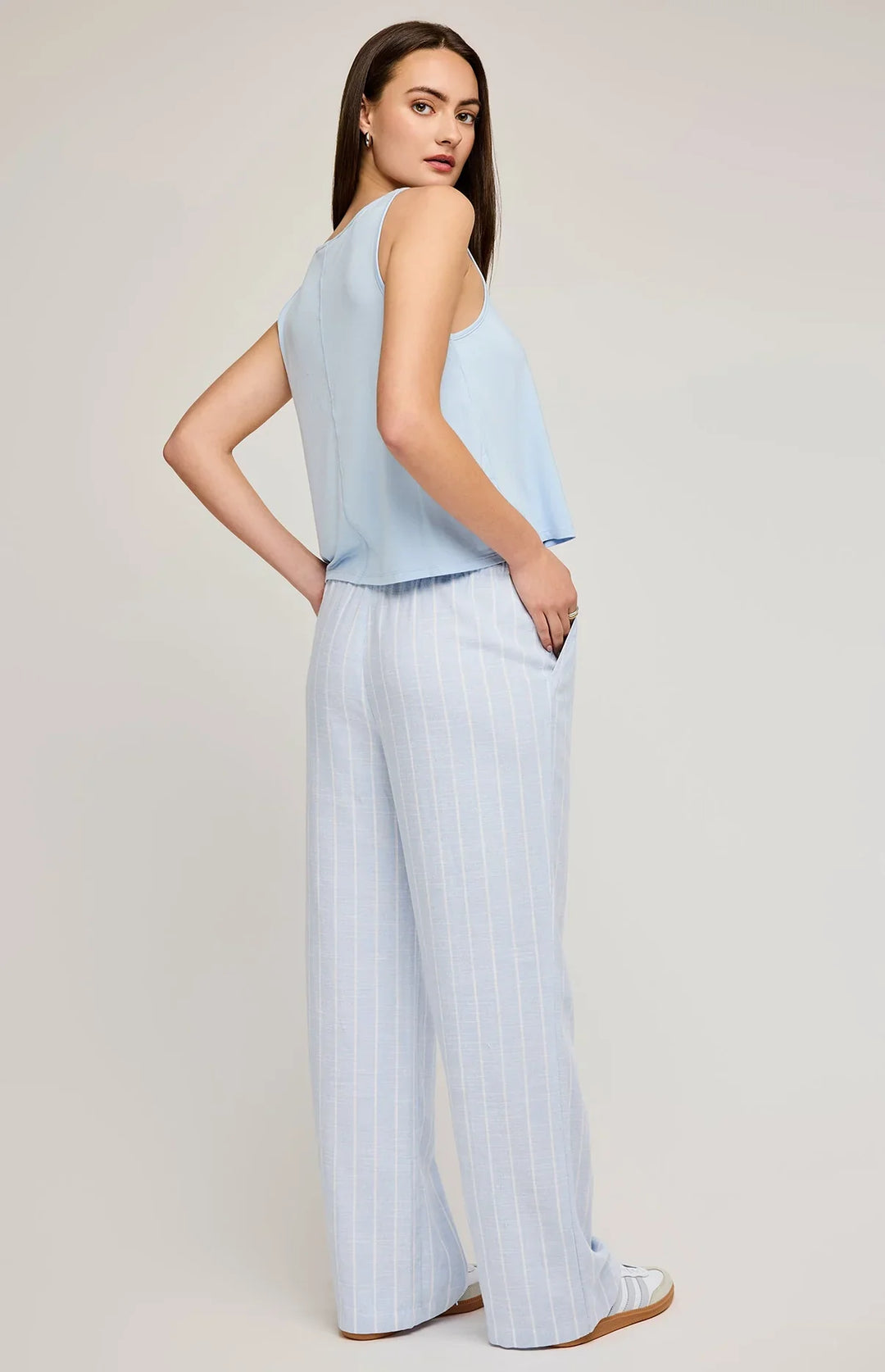 Linen pants feature slash pockets and an elasticated waistband in blue with white stripes by gentle fawn 