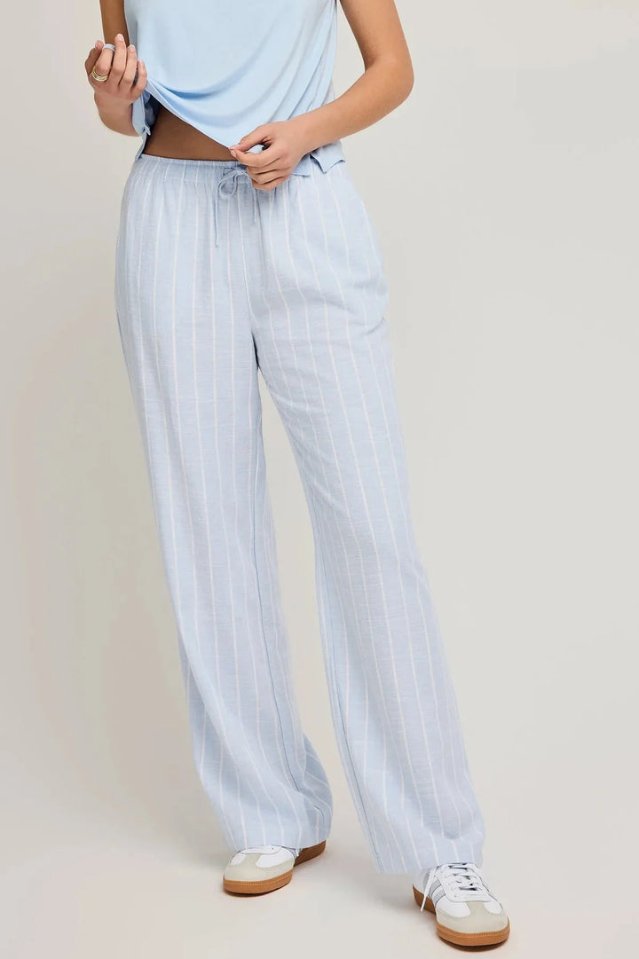 Linen pants feature slash pockets and an elasticated waistband in blue with white stripes by gentle fawn 