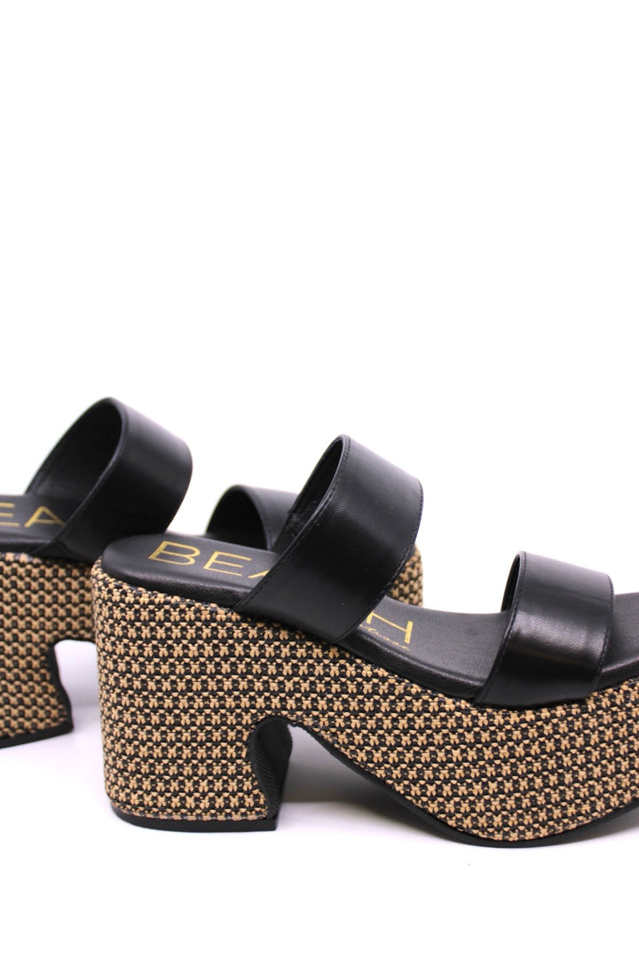 Matisse West Haven Black side view - Dear Lucy Platformed heel sandal with a mixed black and natural raffia on the base and a black leather upper with 2 foot straps.