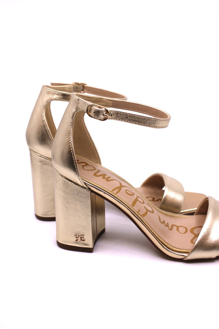 Sam Edelman Daniella Molten Gold side view - Dear Lucy features a wide strap, ankle closure, and sturdy heel, providing a classic and sophisticated appearance
