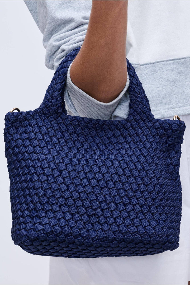 *Material: Polyester *Closure: Snap *Exterior Details: Woven, Adjustable/ detachable shoulder strap 18"-29" *Interior Details: Open Compartment, Removeable Zipper Pouch *Handle Drop: 5"