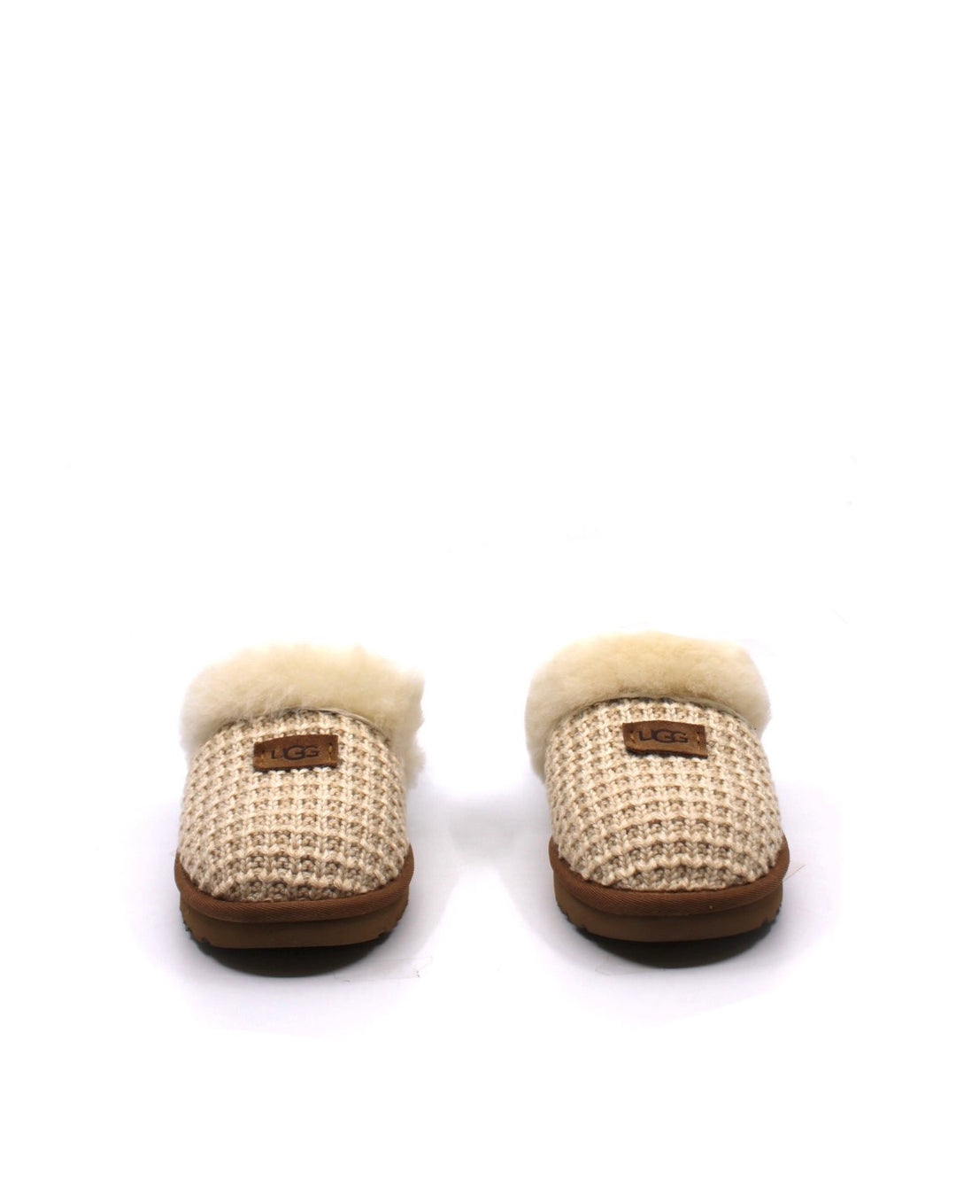 A pair of beige UGG Cozy Cream slippers with a sheepskin lining and a fluffy collar.